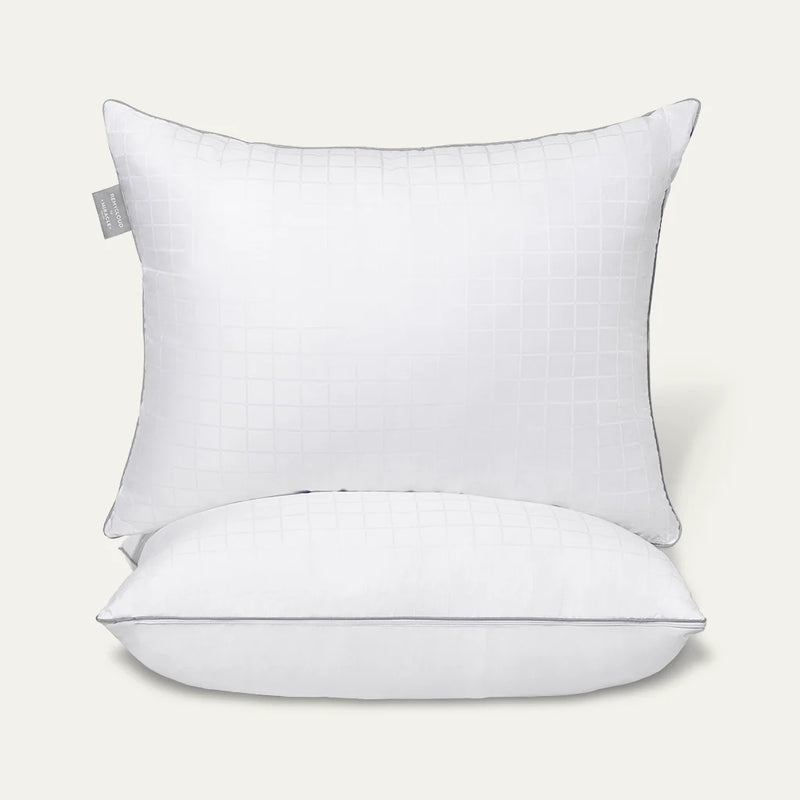 White pillow with a gray tag on a light gray background